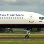 Cover for Easy Flute Solos collection showing the side of an airplane with "Easy Flute Solos" printed on it.